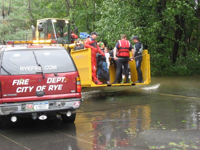 Rye firefighter and police officers rescue residents on Ellsworth St during Hurricane Irene